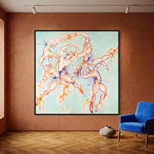 Load image into Gallery viewer, Swans… by IsaLu Ishii – a framed art print depicting playful male ballet dancers wearing tutus in dynamic poses, displayed on a textured terracotta wall in a modern room with a blue armchair and wood floor.
