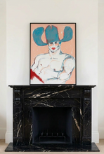 Load image into Gallery viewer, Cowboy In Red... Speedos!! by IsaLu Ishii -framed art print featuring a stylized, cowboy with a blue hat on a peach background, displayed on a black marble fireplace mantel against a white wall.
